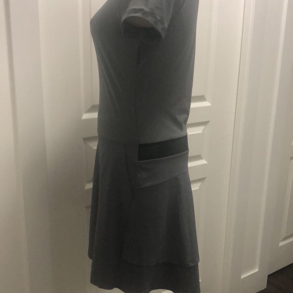 This gray Nike golf dress has flowing skirt in the back. - Picture 2 of 3